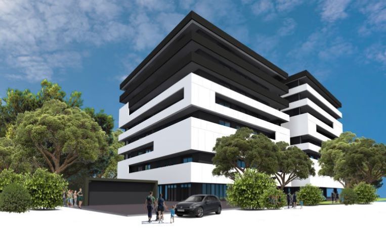 Stanovanjski objekt Levji grad, večnadstropna stavba s črno belo fasado, obdana z drevesi.