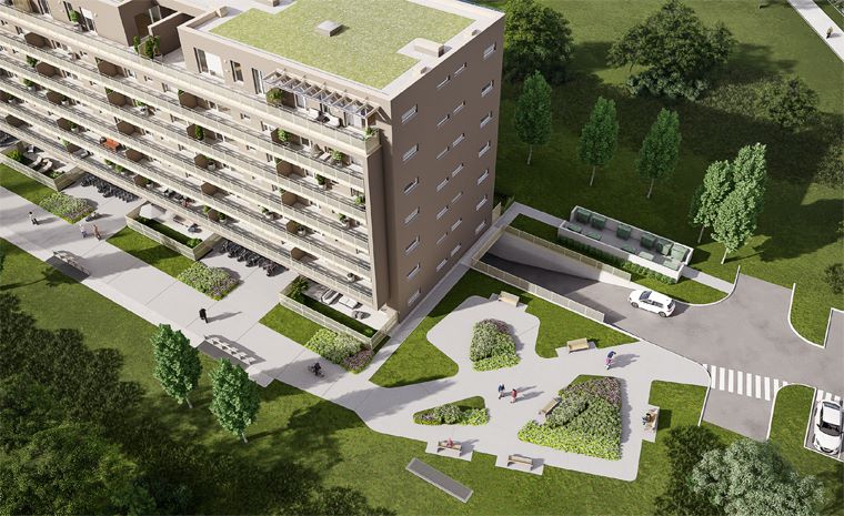 Zračni pogled na večnadstropno stanovanjsko stavbo z balkoni. Okolica stavbe je obdana z zelenimi površinami, drevesi in potmi.